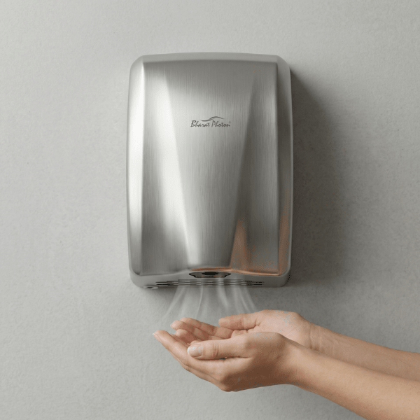 Hand dryer mounted on a wall with hands underneath, demonstrating the use of the hand-dryer.